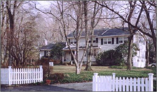 two-story white home with white picket fen purchased or sold by testimonial client, KP